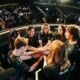 Image of members of the Shopify Rebellion VALORANT Game Changers roster sharing a team huddle on stage during an international tournament