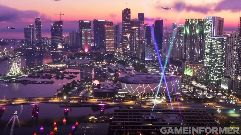 Vista aérea do horizonte iluminado de Vice City ao anoitecer em Grand Theft Auto VI apresentando a Marina de Vice City, uma roda gigante, holofotes sobre a arena e arranha-céus.   