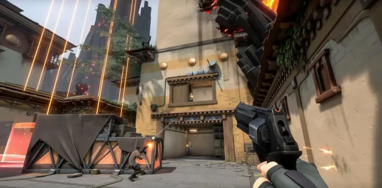 First-person perspective of a player holding a pistol during a match in Valorant.