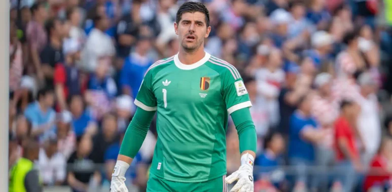 Thibaut Courtois wearing a green Belgium national team goalkeeper kit during a match.