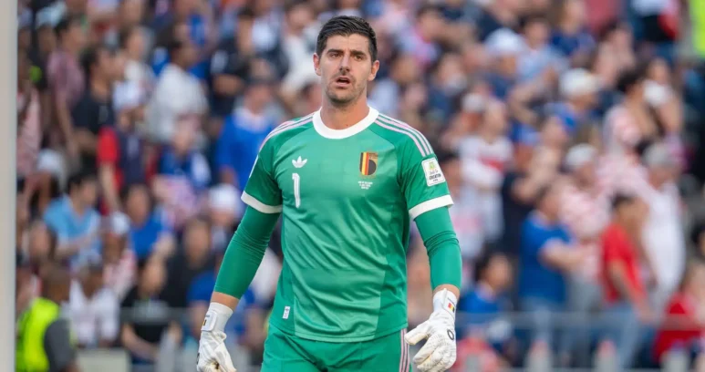 Thibaut Courtois wearing a green Belgium national team goalkeeper kit during a match.