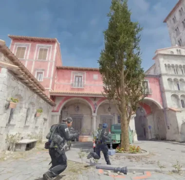 Counter-Strike 2 gameplay showing characters in tactical gear in a Mediterranean-style town square.