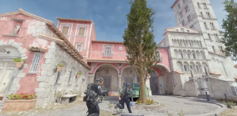 Counter-Strike 2 gameplay showing characters in tactical gear in a Mediterranean-style town square.