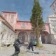 Counter-Strike 2 gameplay showing characters in tactical gear in a Mediterranean-style town square.