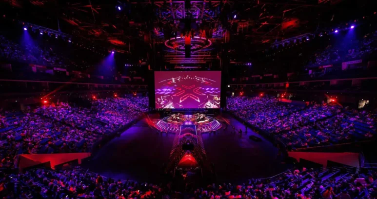 Wide shot of the Valorant Champions Shanghai arena stage and audience under red and purple lighting.