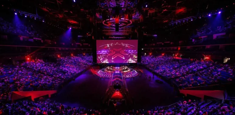 Wide shot of the VALORANT Champions Shanghai arena stage and audience under red and purple lighting.