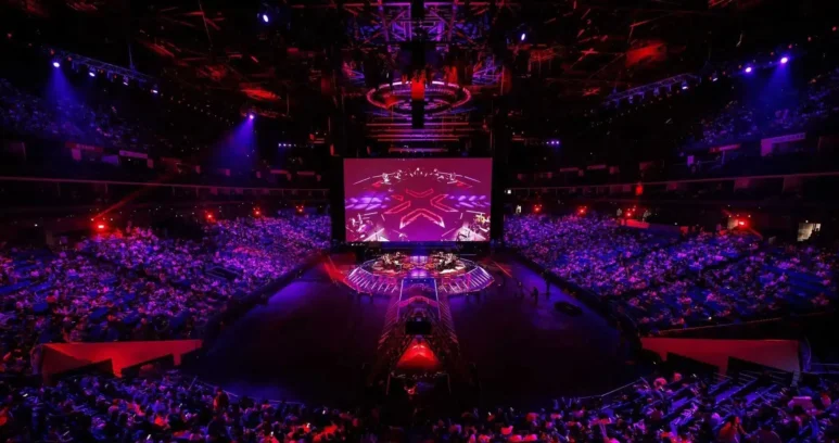 Wide shot of the VALORANT Champions Shanghai arena stage and audience under red and purple lighting.