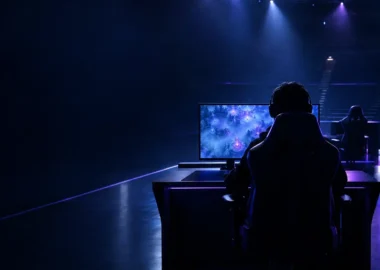 Anonymous esports player at a glowing Dota 2 workstation during a team roster transition