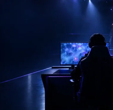 Anonymous esports player at a glowing Dota 2 workstation during a team roster transition
