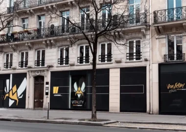 The exterior storefront of Team Vitality V.Hive in Paris, featuring the team's logo and branding on black panels.