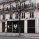 The exterior storefront of Team Vitality V.Hive in Paris, featuring the team's logo and branding on black panels.