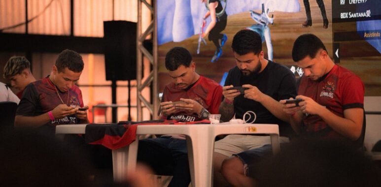 Players competing on smartphones at a mobile esports tournament