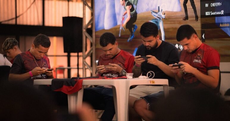 Players competing on smartphones at a mobile esports tournament