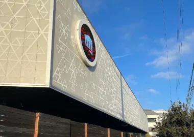 The exterior of the Riot Games headquarters featuring the company logo on the building facade.