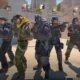 A group of Counter-Strike 2 operatives standing in a sunny outdoor environment.
